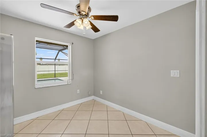 Spare room featuring a ceiling fan and light tile patterned floors