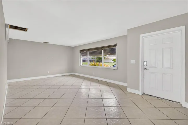 Foyer entrance featuring light tile patterned flooring