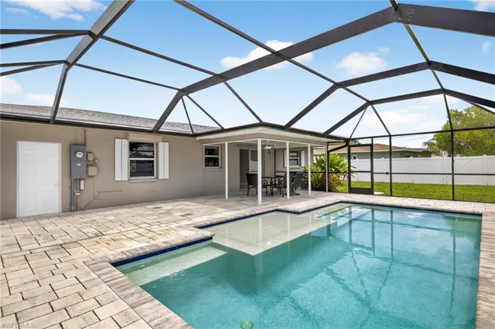 View of pool with a patio, a lanai, and outdoor dining area