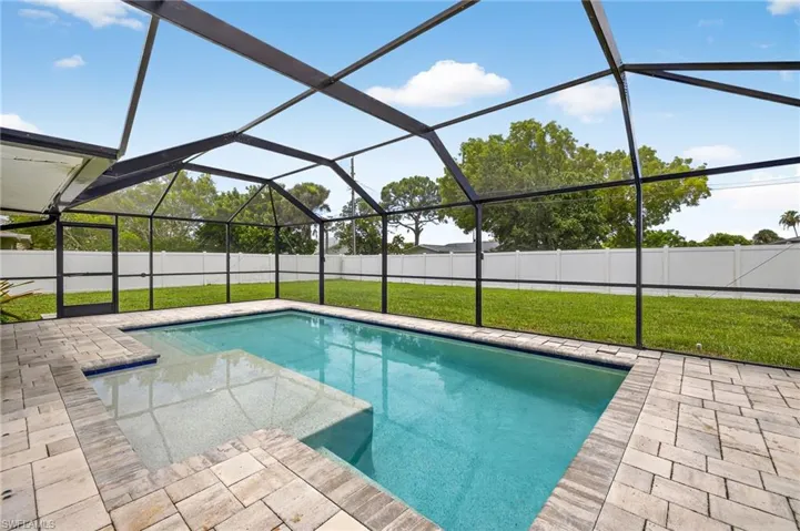 View of swimming pool with a patio area, a fenced backyard, and a lanai