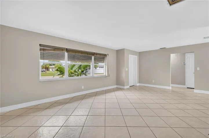 Spare room featuring baseboards and light tile patterned floors