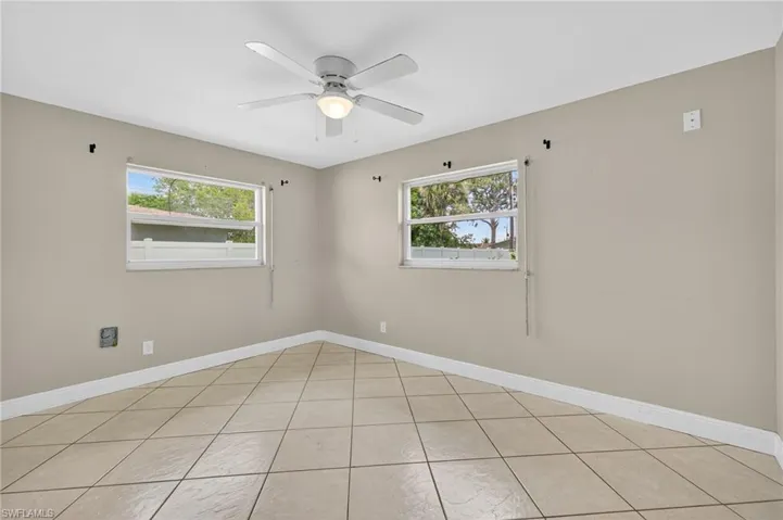 Unfurnished room featuring ceiling fan and light tile patterned floors