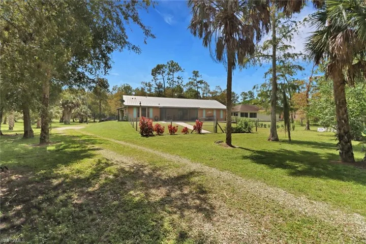 View of front of home featuring a sunroom and a front yard