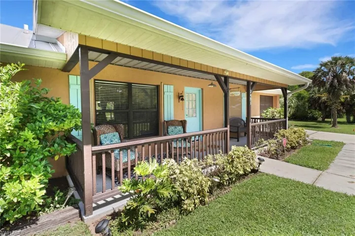 Entrance to property with a yard and a porch