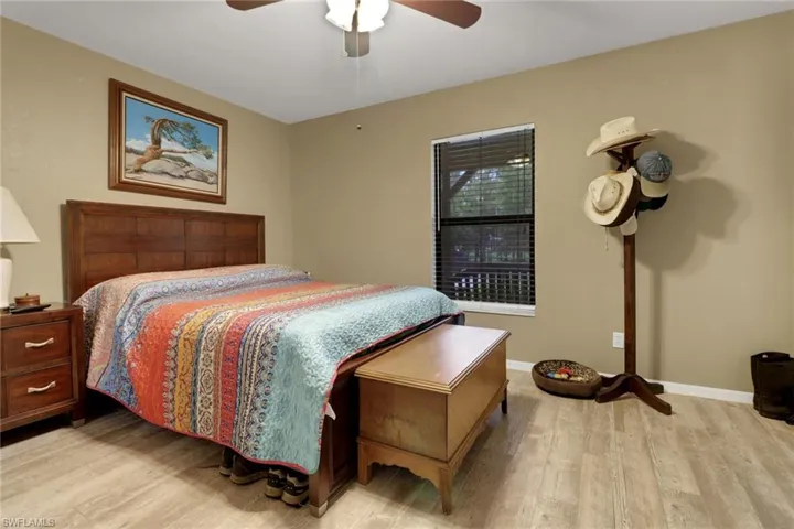Bedroom with light hardwood / wood-style floors and ceiling fan