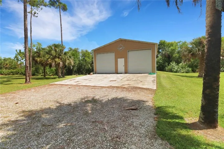 Garage featuring a lawn