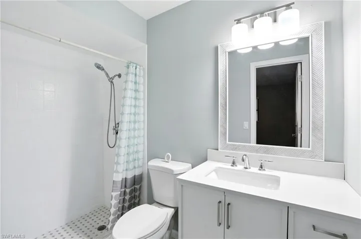 Full bath featuring vanity and a stall shower
