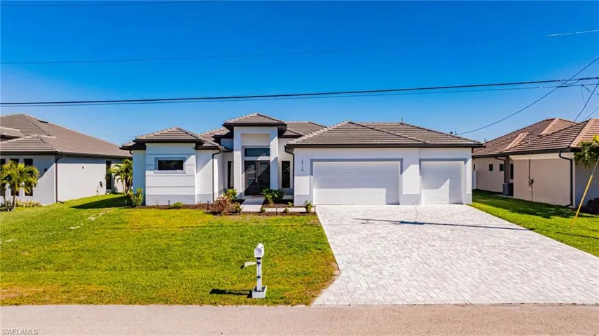 Prairie-style house with a front lawn, stucco siding, an attached garage, a tile roof, and driveway