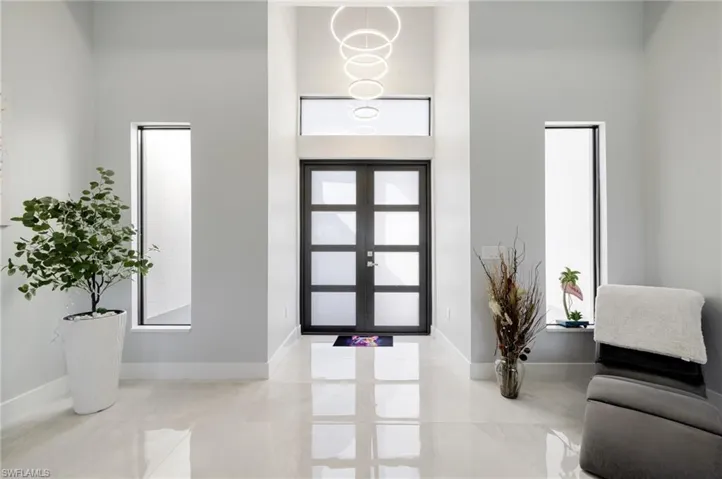 Entryway with a high ceiling and french doors