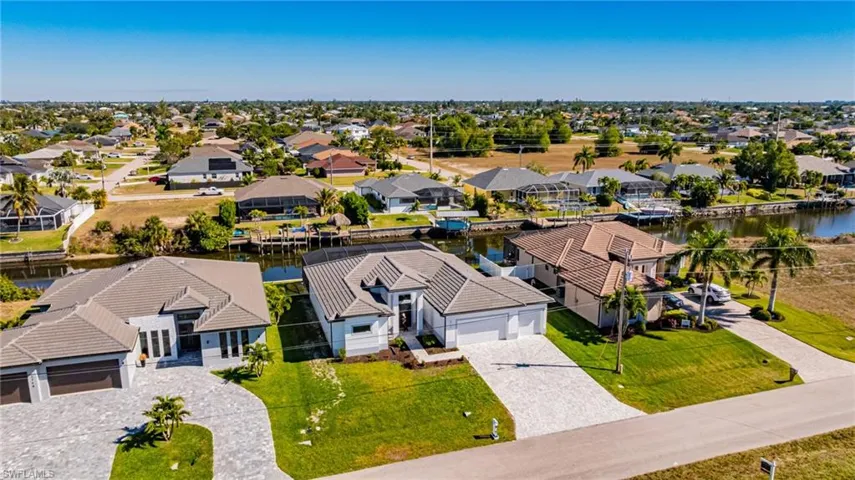 Aerial view of residential area featuring a large body of water
