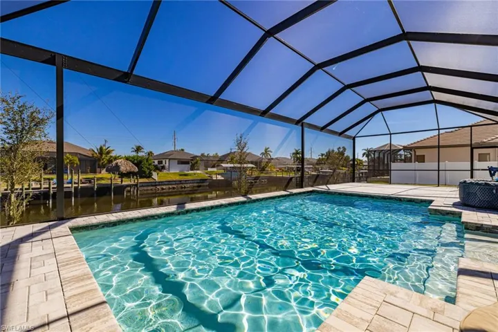 View of pool featuring a residential view, a sunroom, and a lanai