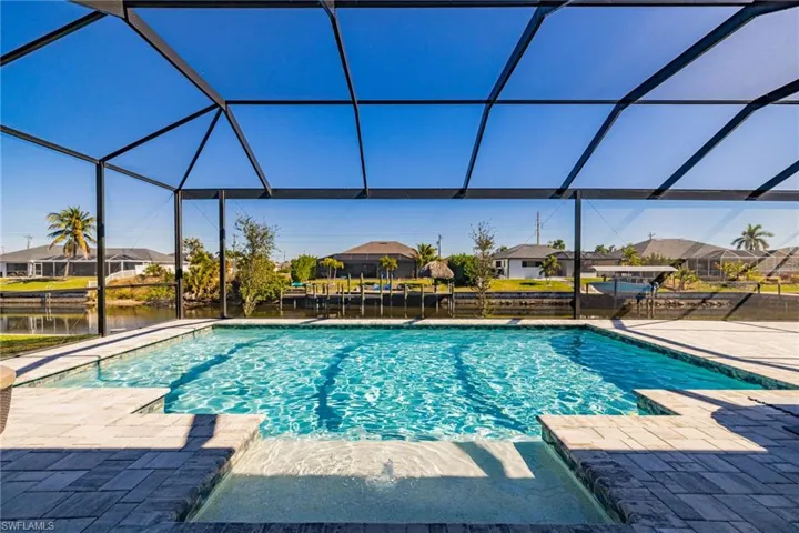 Outdoor pool with a residential view, a sunroom, a lanai, and a patio