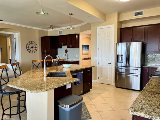 Gourmet kitchen with large pantry and breakfast bar area