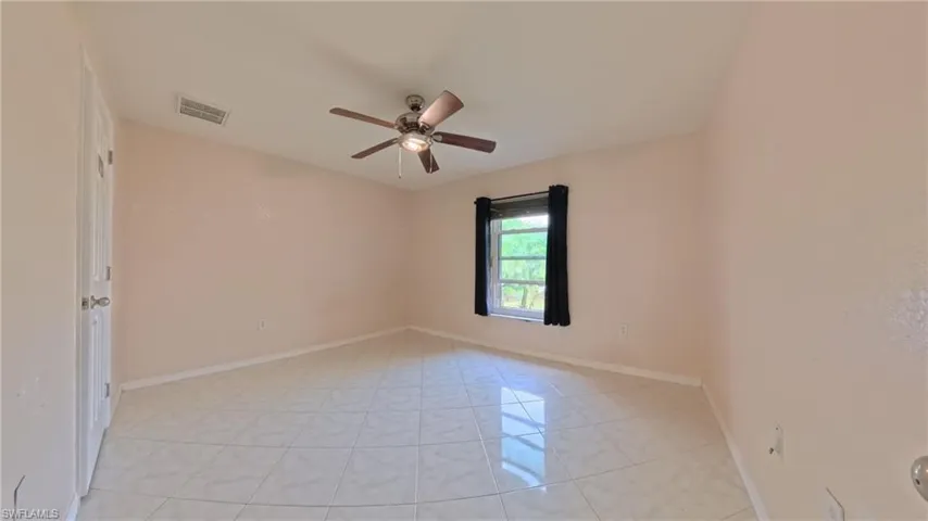 Guest bedroom 3 featuring ceiling fan and tiled flooring
