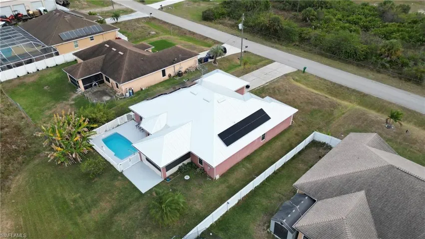 Aerial view of property and surrounding area featuring pool
