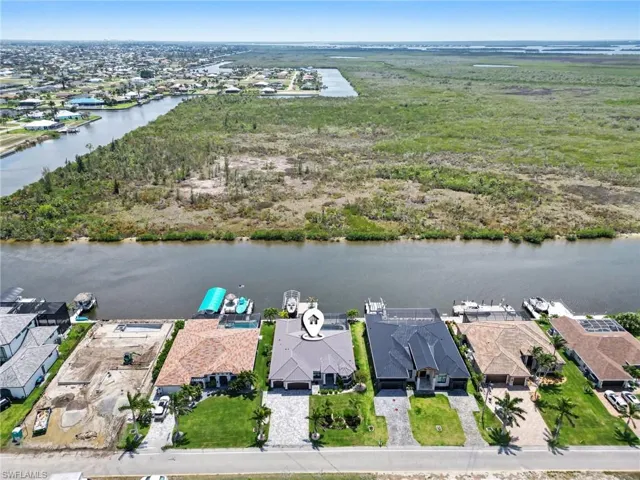 This property offers direct access to a canal, featuring a private boat dock