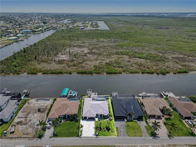 Aerial view of the property, showcasing its location along a canal with direct water frontage