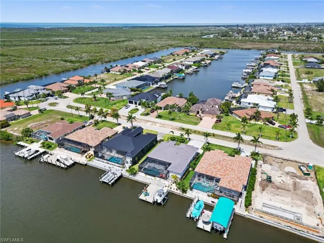 This property is part of a waterfront community featuring a canal with boat docks and direct access to a larger body of water