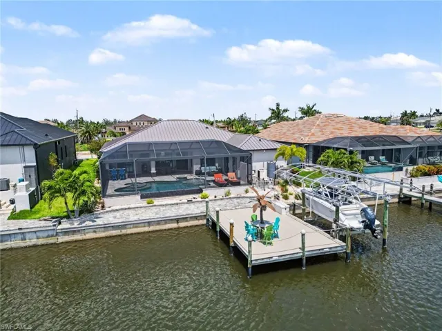 The property features a screened-in lanai with a swimming pool and spa