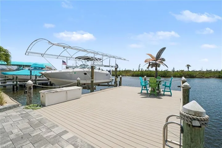 The property features a spacious dock with boat lifts, providing direct water access-NO bridges