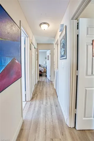 Hallway with light hardwood / wood-style flooring