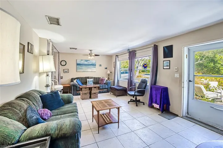 Tiled living room featuring ceiling fan
