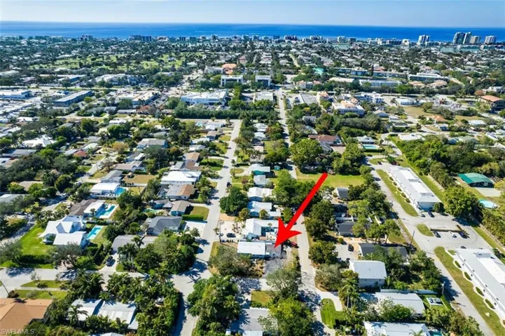 Birds eye view of property with a water view