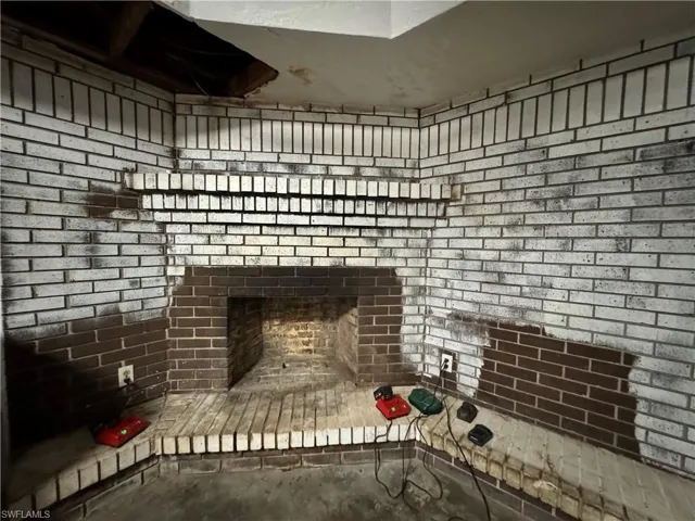 Room details featuring a brick fireplace