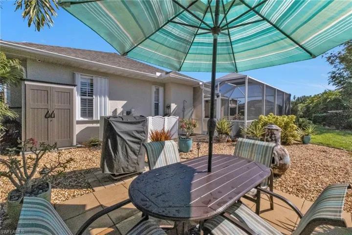 View of patio / terrace with glass enclosure and a shed