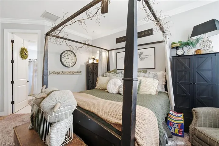 Bedroom featuring crown molding and carpet
