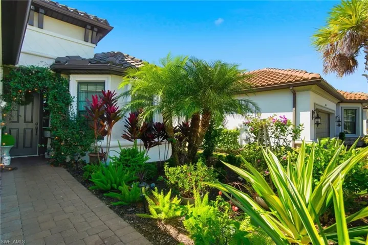 View of side of property with a tiled roof and stucco siding