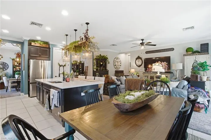 Dining space featuring crown molding, light tile patterned floors, a ceiling fan, and recessed lighting
