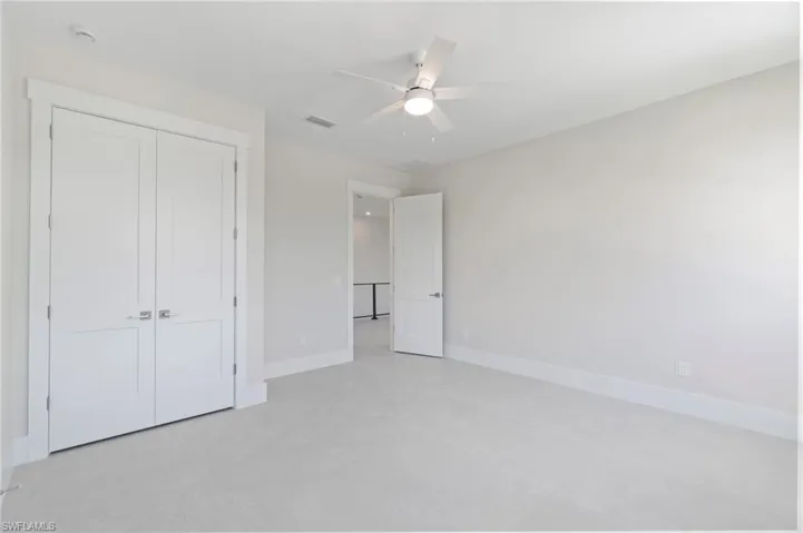 Unfurnished bedroom featuring a ceiling fan and a closet