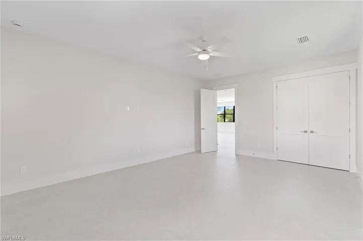 Unfurnished bedroom featuring a closet and a ceiling fan