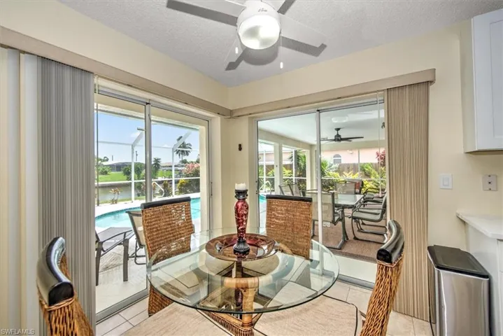 Tiled dining space featuring a textured ceiling and ceiling fan