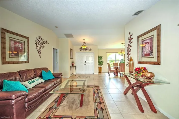 Tiled living room featuring a textured ceiling
