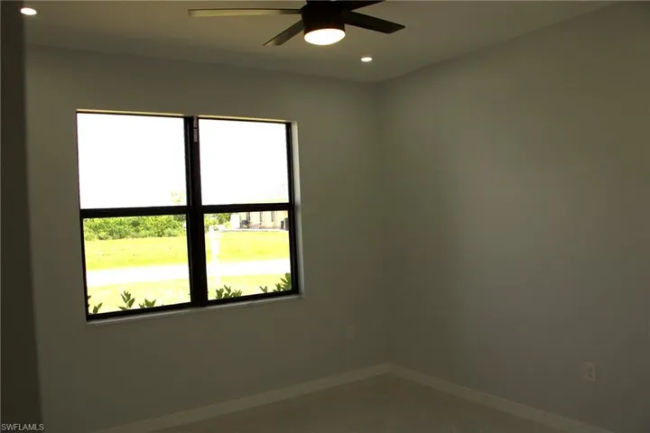 Empty room with ceiling fan and recessed lighting