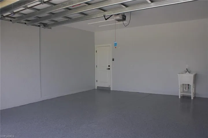 Garage featuring a sink and a garage door opener