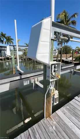 Dock area with boat lift and a water view