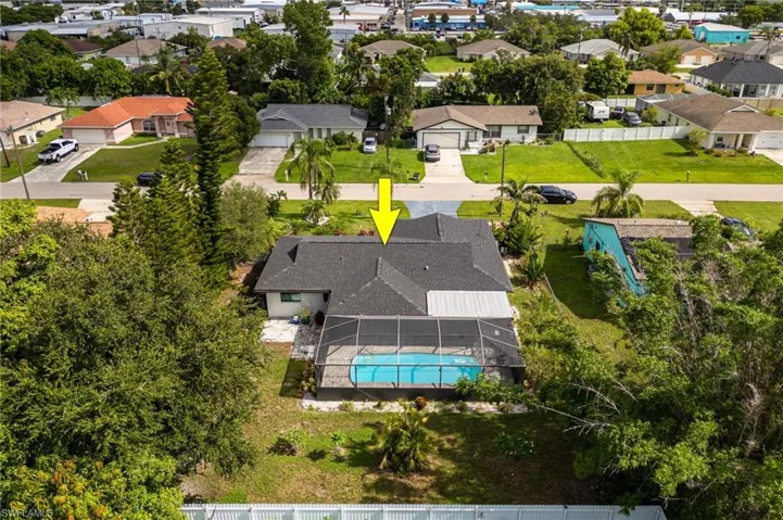 Aerial view of residential area featuring a pool