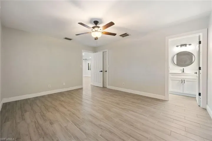 Kitchen featuring recessed lighting, wood tiled floors, hanging light fixtures, a kitchen island, and appliances with stainless steel finishes