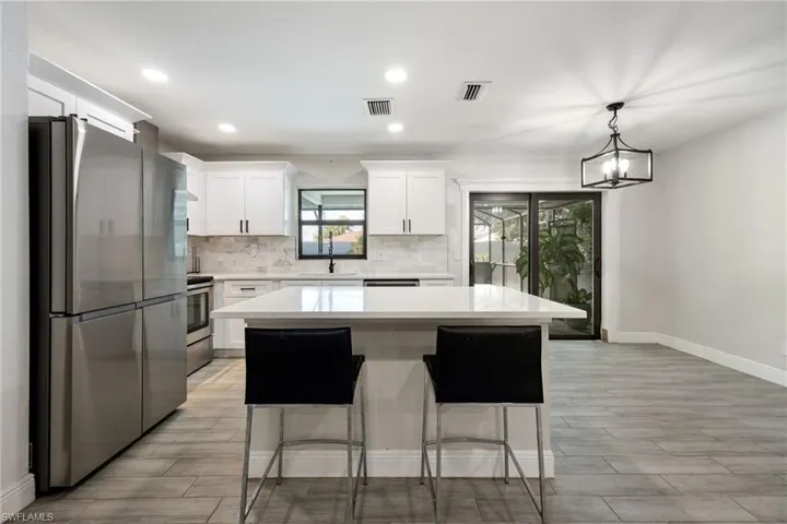 Single story home featuring an attached garage, driveway, stucco siding, and a front lawn