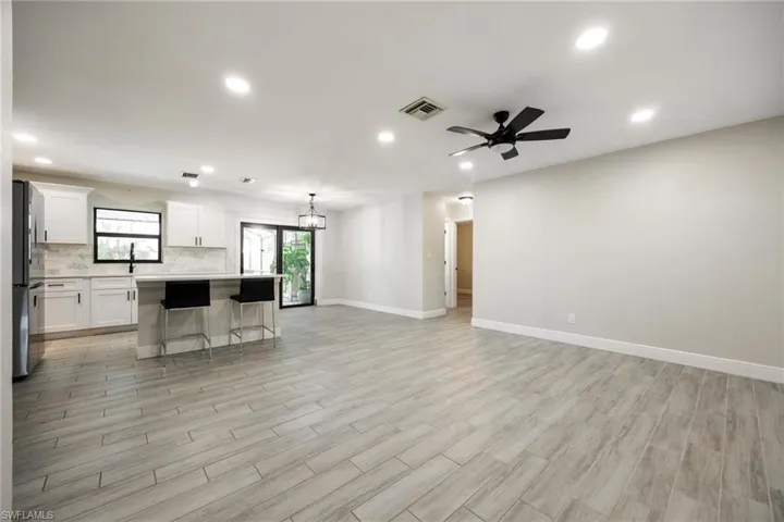 Bedroom with wood finished floors, a ceiling fan, and a closet