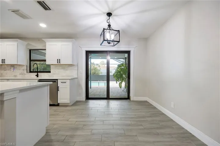Kitchen with appliances with stainless steel finishes, tasteful backsplash, recessed lighting, a kitchen island, and a kitchen breakfast bar