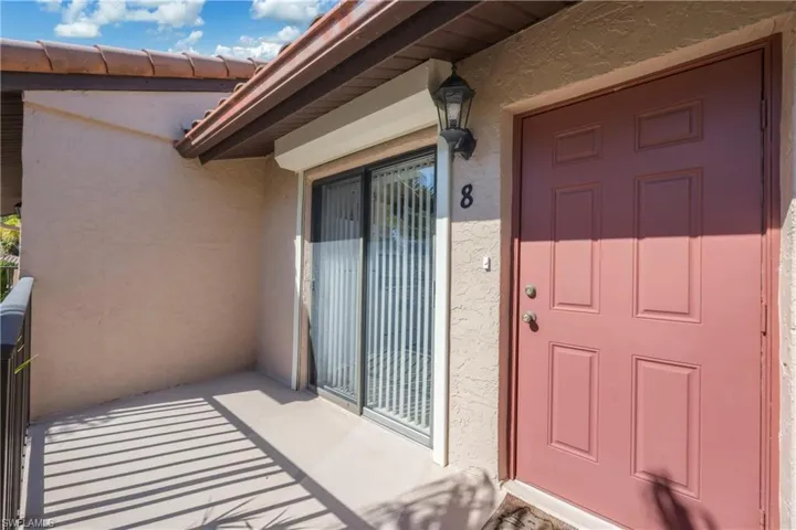 Entrance to property with stucco siding