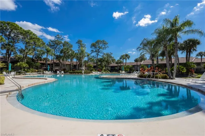 Community pool featuring a patio area and a hot tub