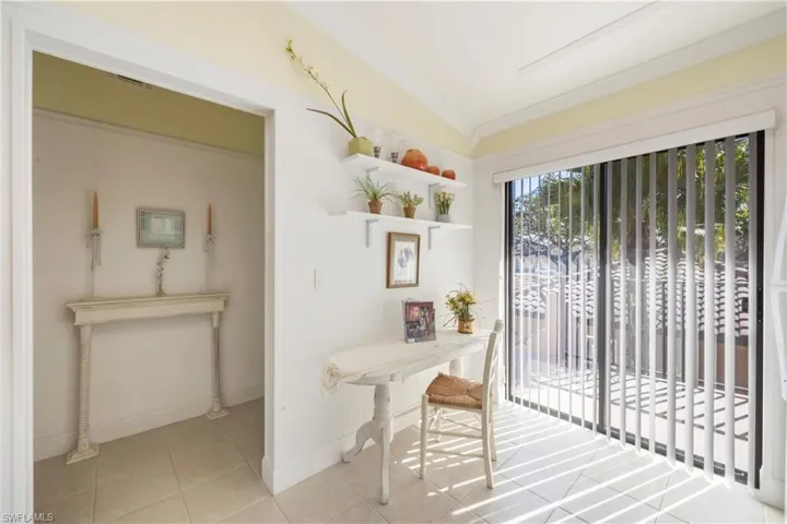 Entryway featuring crown molding and tile patterned floors