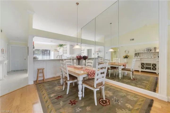 Dining space featuring light wood-style flooring and high vaulted ceiling
