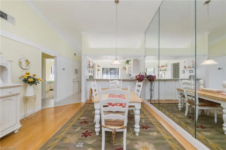 Dining room featuring ornamental molding and wood finished floors