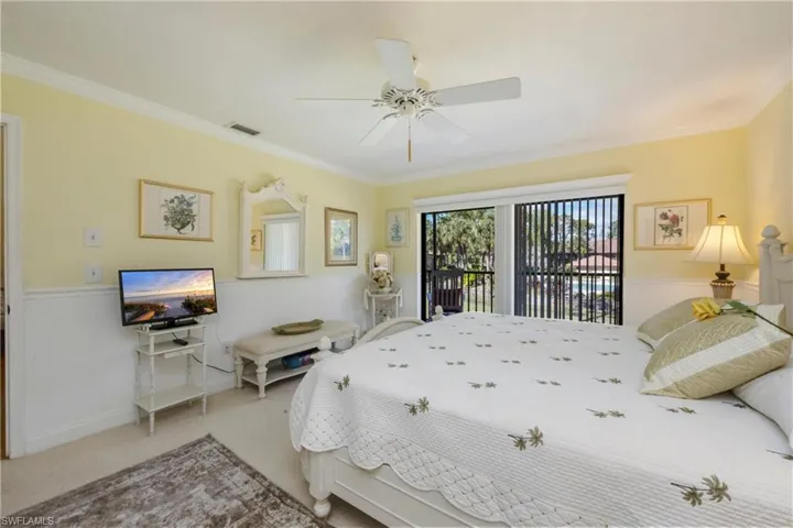 Bedroom with access to outside, carpet floors, crown molding, and a ceiling fan